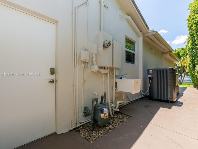 view of property exterior featuring sink and central air condition unit