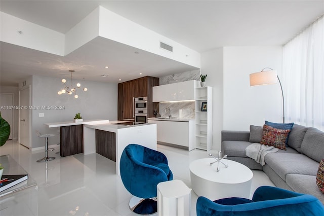 tiled living room featuring a notable chandelier and sink