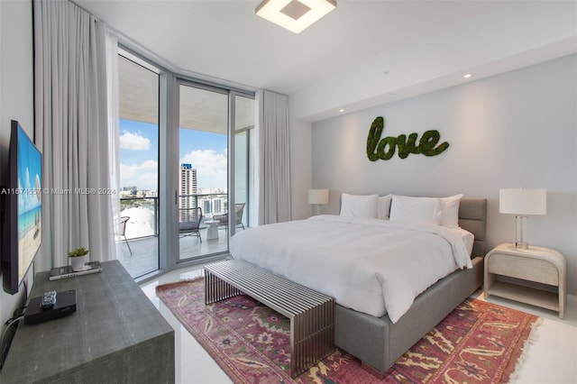 bedroom featuring access to outside and a wall of windows