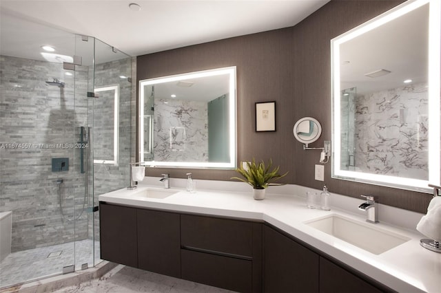 bathroom with vanity and a shower with door