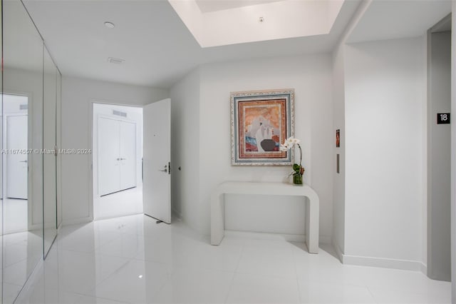 hall with light tile patterned floors