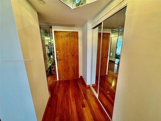 corridor featuring wood finished floors