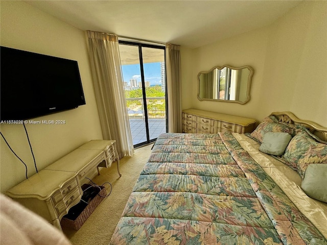 bedroom with a wall of windows, access to outside, and carpet