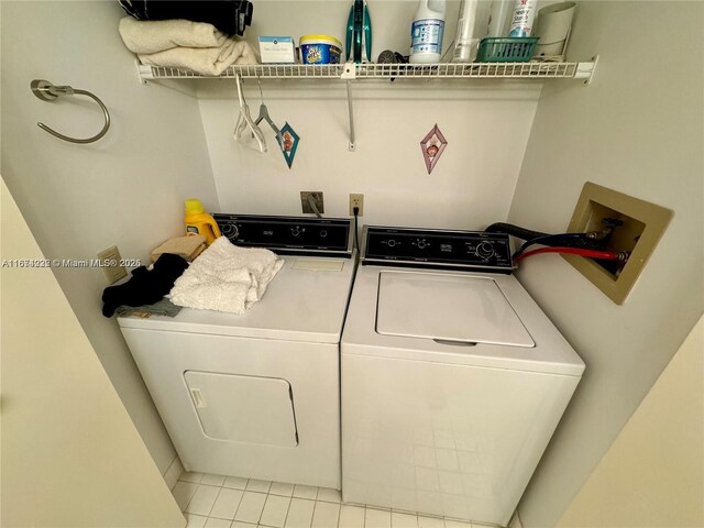 washroom featuring separate washer and dryer and light tile patterned floors