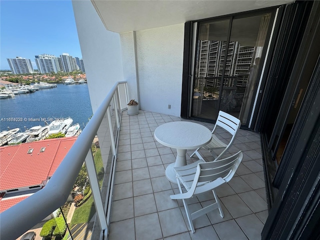 balcony with a water view and a city view