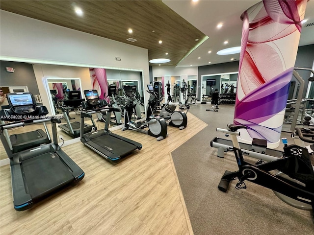 workout area with light hardwood / wood-style floors