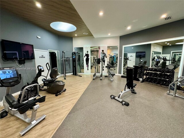 exercise room with hardwood / wood-style floors