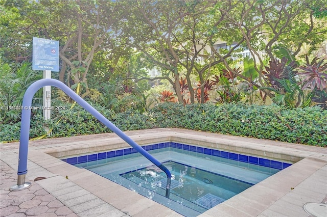 view of swimming pool featuring a community hot tub