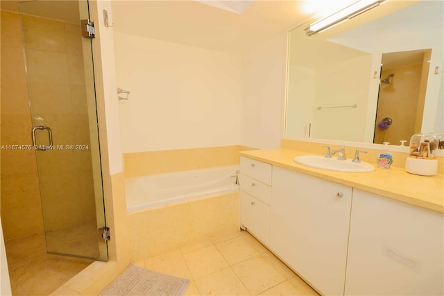 bathroom with vanity, plus walk in shower, and tile patterned flooring