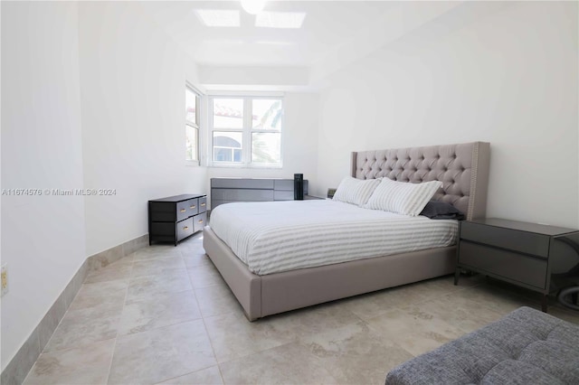 bedroom with light tile patterned floors