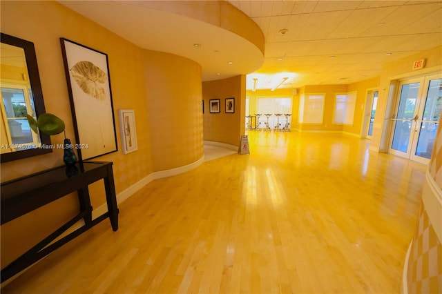 hallway featuring french doors and hardwood / wood-style flooring