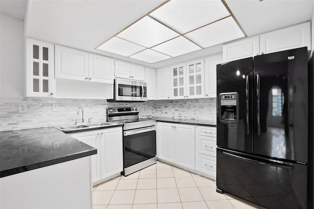 kitchen with white cabinets, appliances with stainless steel finishes, sink, and tasteful backsplash