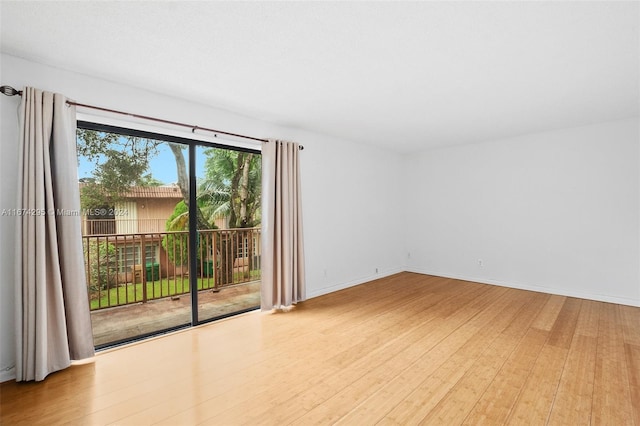 empty room with light hardwood / wood-style flooring