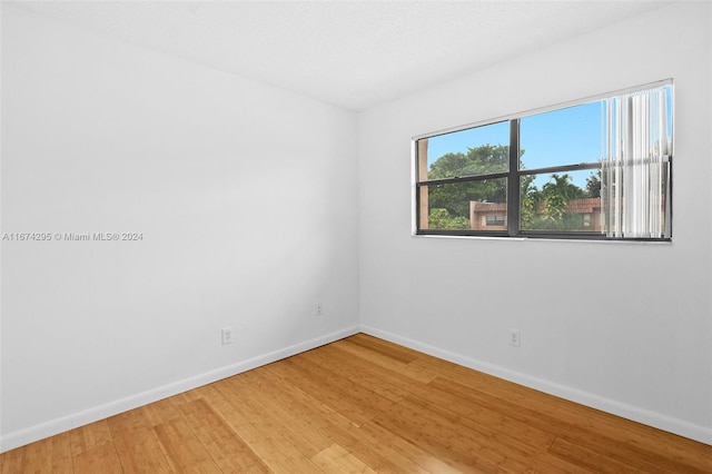 spare room with wood-type flooring