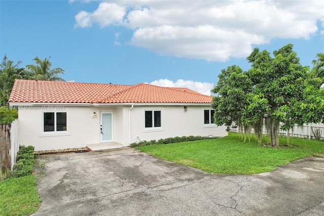 mediterranean / spanish house featuring a front lawn