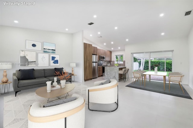 living room featuring vaulted ceiling