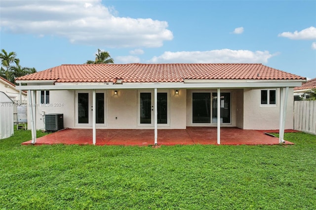 rear view of property featuring central AC, a lawn, and a patio area