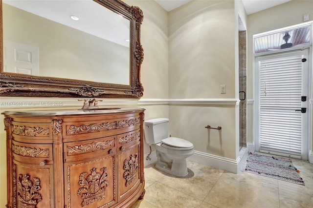 full bath with tile patterned flooring, toilet, vanity, baseboards, and a stall shower