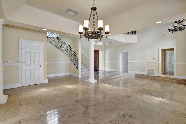 interior space with ornate columns and a chandelier