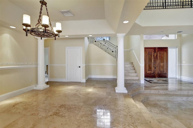 entryway with recessed lighting, ornate columns, visible vents, stairway, and baseboards