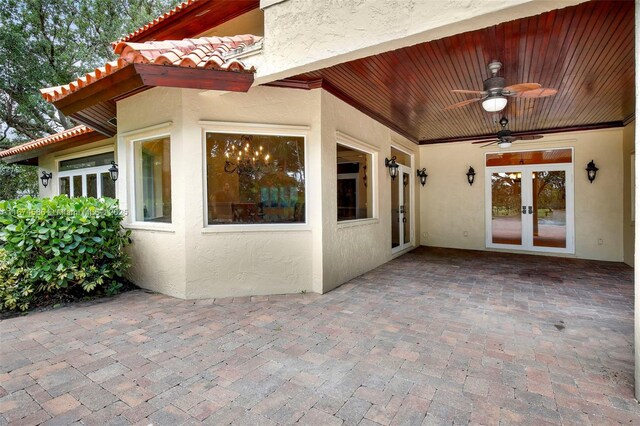 back of property with a balcony, a lawn, a patio area, and a fenced in pool