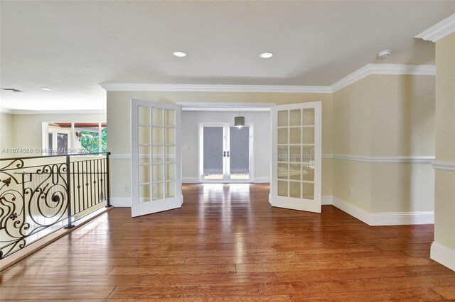 spare room with french doors, hardwood / wood-style floors, and ornamental molding