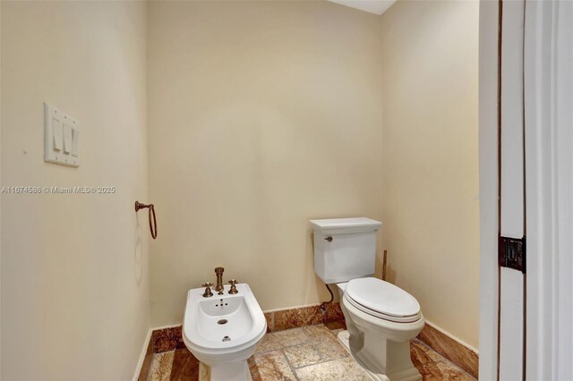 bathroom featuring a bidet and toilet