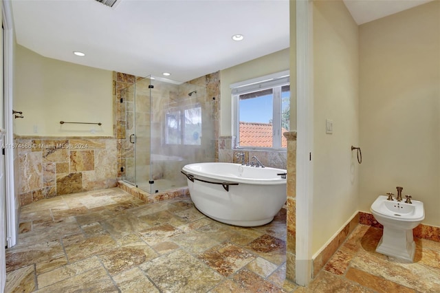 bathroom with a bidet, separate shower and tub, and tile walls