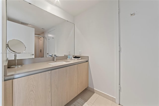 bathroom featuring tile patterned flooring and vanity