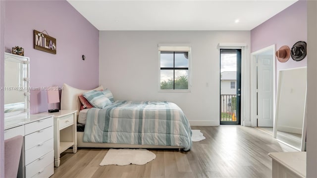 bedroom featuring light hardwood / wood-style floors and access to outside