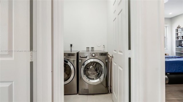 laundry room featuring light hardwood / wood-style flooring and washer and dryer