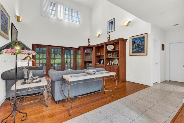 tiled living room featuring a high ceiling