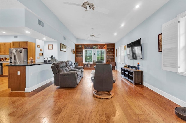 living room with french doors, light wood-type flooring, vaulted ceiling, and ceiling fan