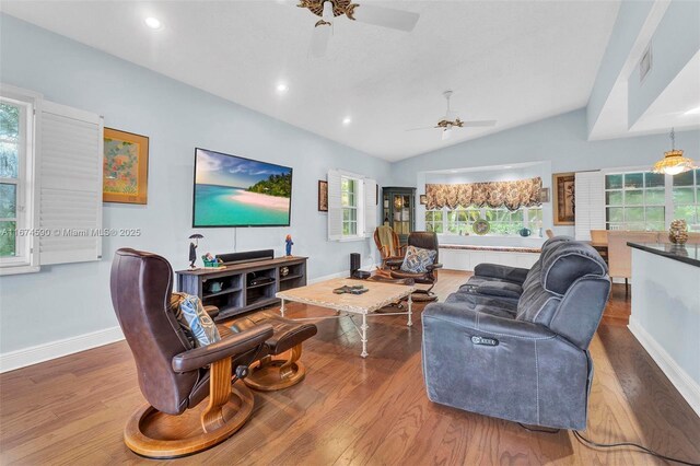 living room featuring ceiling fan, hardwood / wood-style floors, and lofted ceiling