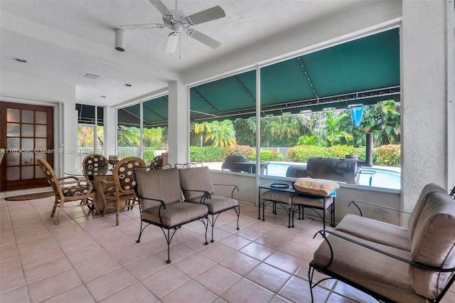 sunroom with plenty of natural light and ceiling fan