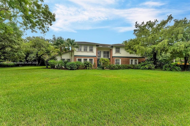 raised ranch with a front lawn