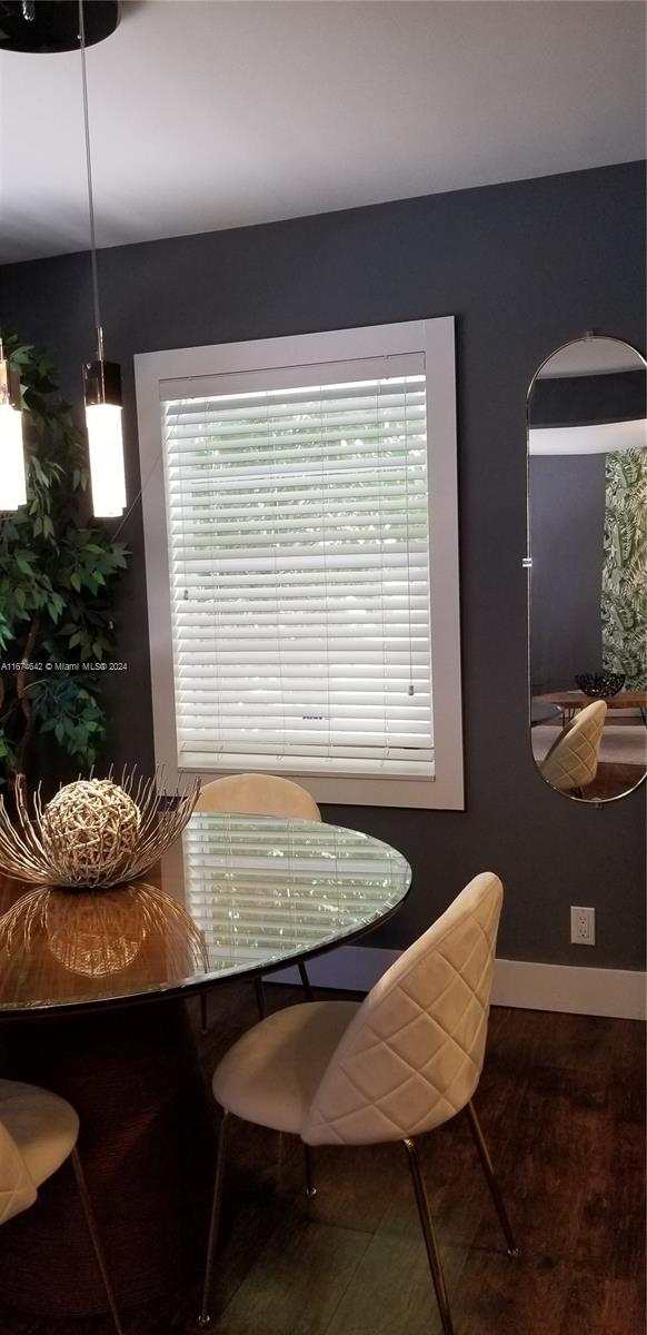 dining space featuring hardwood / wood-style floors and a healthy amount of sunlight