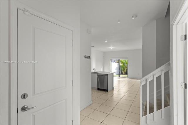 hallway with sink and light tile patterned floors