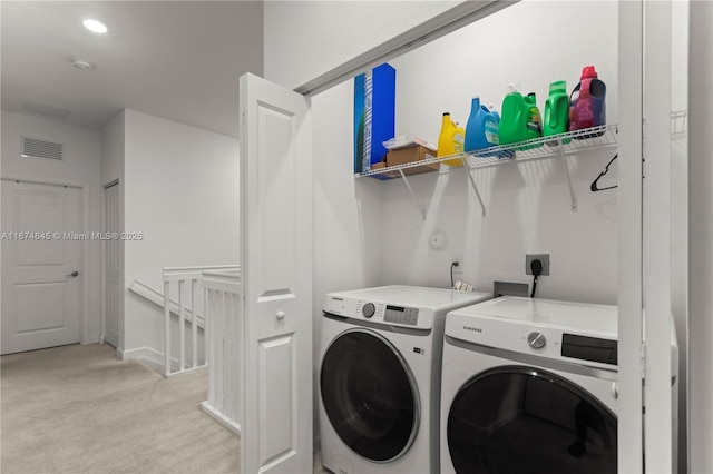 laundry room with light carpet and independent washer and dryer