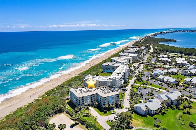 drone / aerial view featuring a view of the beach and a water view