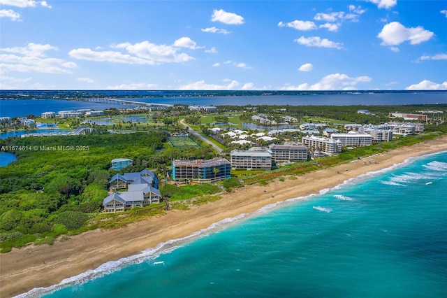 birds eye view of property with a water view and a view of the beach