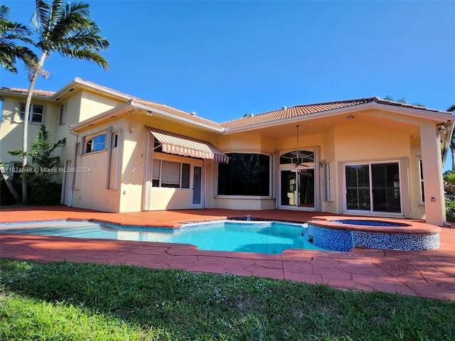 321 Windmill Palm Ave, Plantation, FL 33324 - back of house with stucco siding, a tile roof, and a pool with connected hot tub