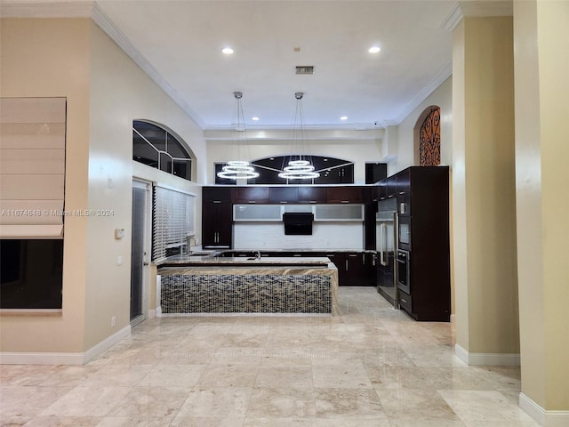 kitchen with ornamental molding, built in refrigerator, sink, and a chandelier