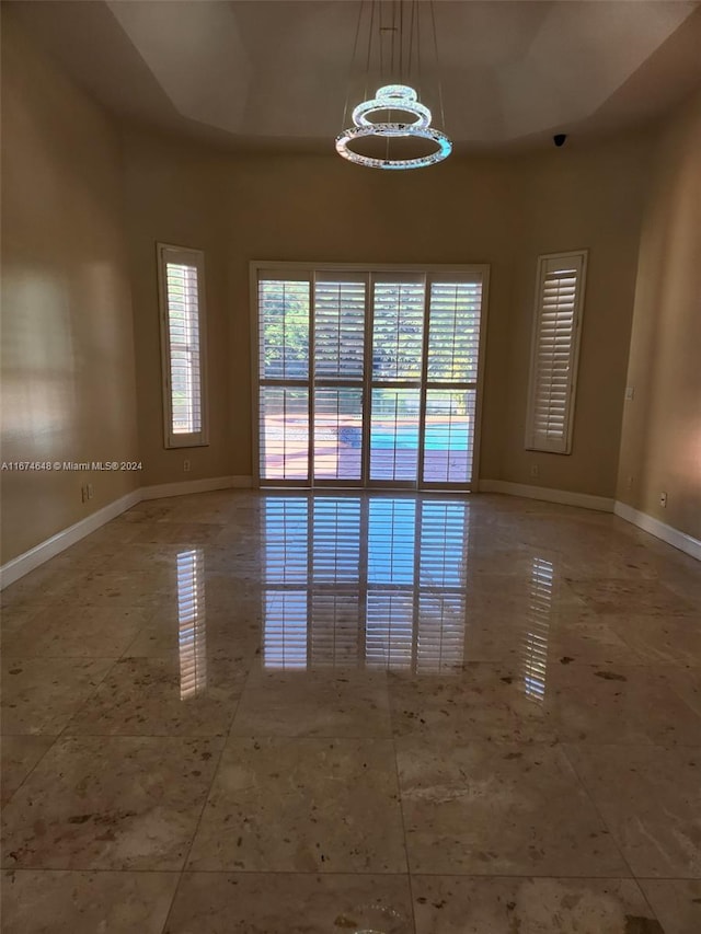 empty room featuring a chandelier