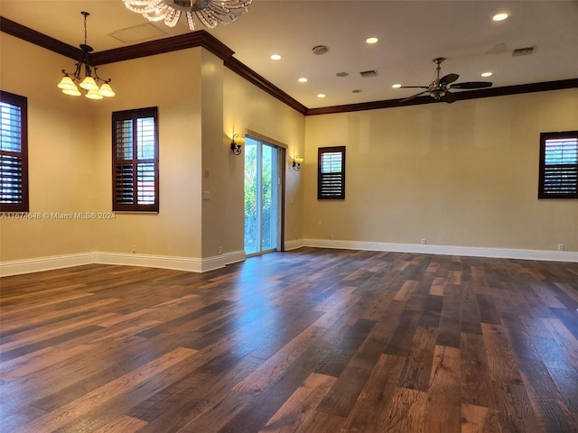 spare room featuring ceiling fan with notable chandelier, dark hardwood / wood-style floors, and ornamental molding