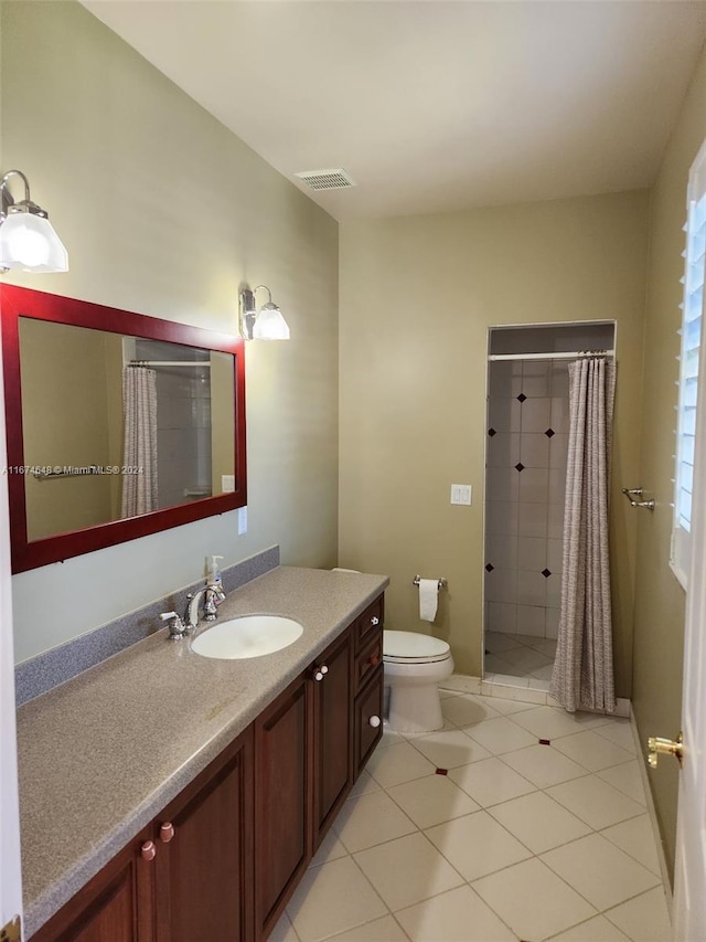 bathroom featuring a shower with curtain, tile patterned floors, vanity, and toilet