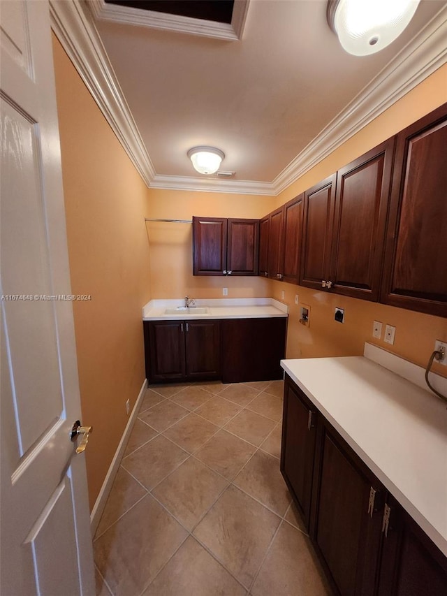 laundry area with light tile patterned flooring, sink, cabinets, hookup for a washing machine, and crown molding