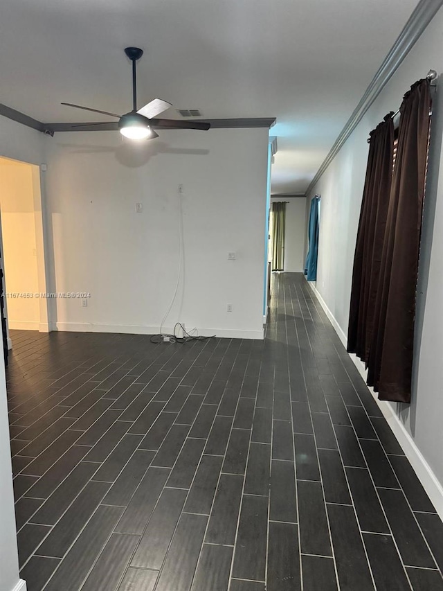 spare room with ceiling fan, crown molding, and dark hardwood / wood-style floors