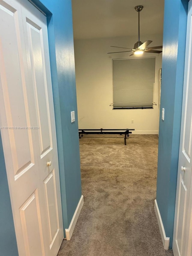 hall with carpet floors and baseboard heating