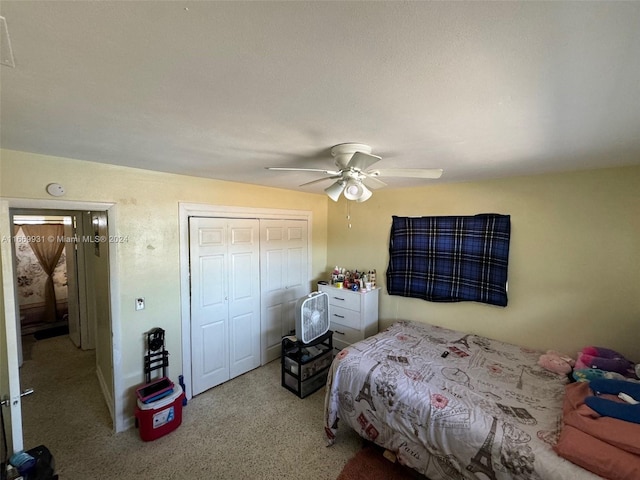 carpeted bedroom featuring a closet and ceiling fan